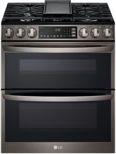 two ovens side by side with the top open