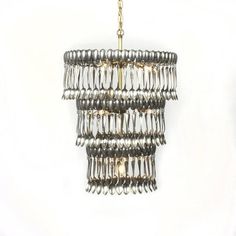 a chandelier hanging from a chain on a white wall