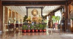 the entrance to a hotel with potted plants