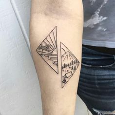 a man with a tattoo on his arm has a mountain scene in the shape of a triangle