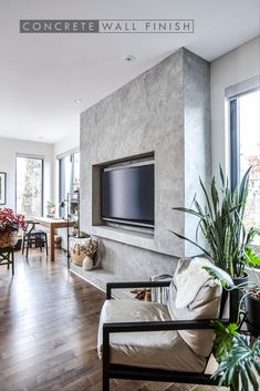 a living room with a large flat screen tv mounted to the side of a wall