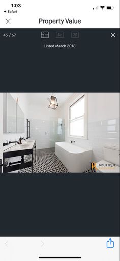 a bathroom with black and white tiles on the floor, and an image of a bathtub