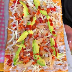 a pizza with toppings on it sitting on top of a table