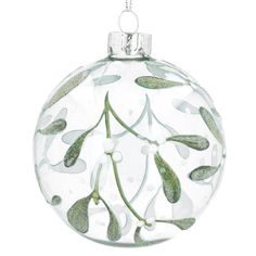 a glass ornament with green leaves on it