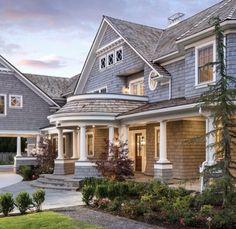 a large house with lots of windows in the front yard