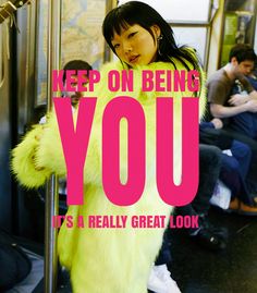 a woman in a yellow fur coat standing on a train with the words, keep on being you it's really great look