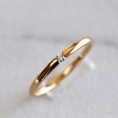 a gold ring with two diamonds on it