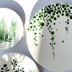 three plates with different designs on them, one is green and the other is white