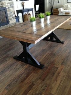 a wooden table sitting on top of a hard wood floor