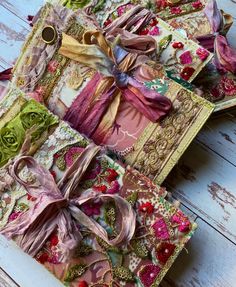 three pieces of fabric with different designs on them sitting on a wooden table next to each other