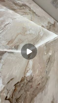 a close up of a marble counter top with an arrow pointing to the left side