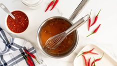 the sauce is being whisked into the bowl