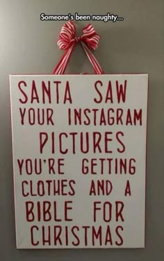 a sign hanging on the wall that says santa saw your instagram pictures you're getting clothes and a bible for christmas