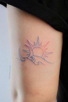 a woman's arm with a small sun tattoo on the left side of her body