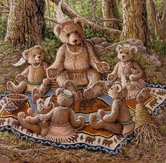 a group of teddy bears sitting on top of a blanket in the woods