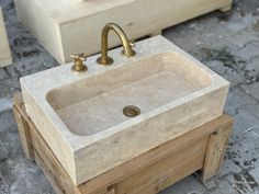 a sink made out of wood with two faucets