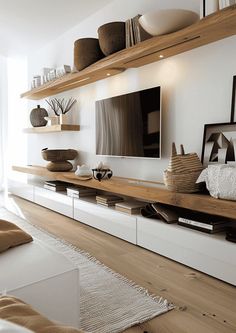 a living room filled with furniture and a flat screen tv on top of a wooden shelf