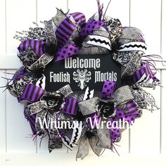 a purple and black wreath with the words welcome