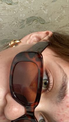 a close up of a person wearing sunglasses with their eyes covered by an eye cloth