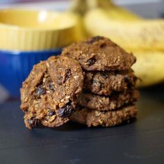 a stack of cookies sitting on top of a table next to a bowl of bananas