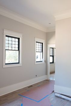 an image of the inside of a house being remodeled with paint and new flooring