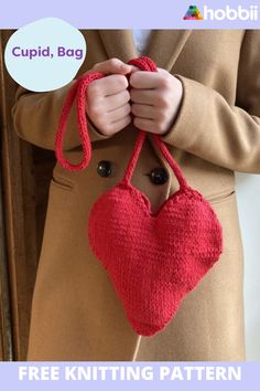 a knitted heart hanging from a hook with the text cupid bag free knitting pattern