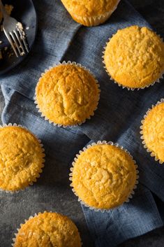 several muffins sitting on top of a blue cloth