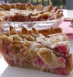 two pies sitting on top of a table next to each other in plastic containers