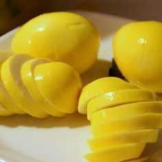 some yellow fruit is sitting on a white plate