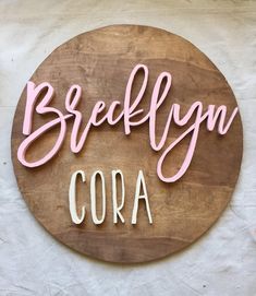 a wooden sign that says breflyn cora on the side of a wall