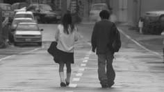 a man and woman walking down the street