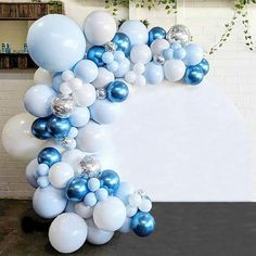 blue and white balloons are arranged in the shape of an x