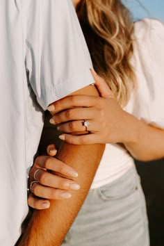 a man and woman holding each other's hands