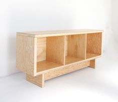 a wooden shelf with three compartments on one side