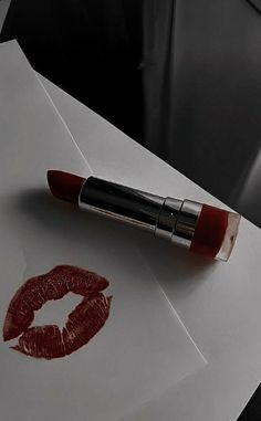 a red lipstick on top of an envelope