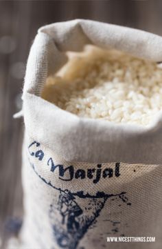 a bag filled with rice sitting on top of a wooden table