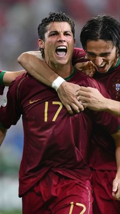 two soccer players are hugging each other while celebrating their team's win over country