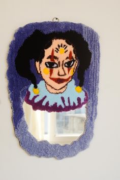 a mirror with a painting of a woman's face on it