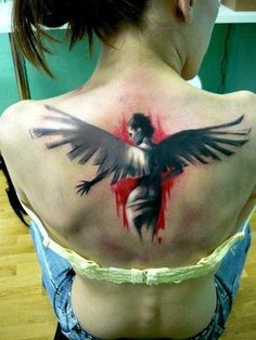 a woman with a tattoo on her back