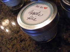 three jars with labels on them sitting on a counter