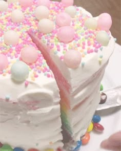 a cake with white frosting and sprinkles on it