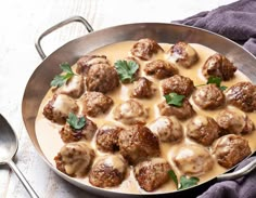 meatballs and gravy in a skillet on a table