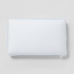 a white pillow with blue piping on it