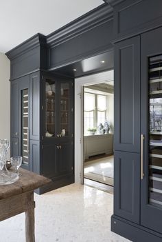 an instagram photo of a kitchen with blue cabinets and glassware on the counter