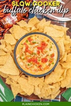 an image of a plate of food with chips and salsa on it that says slow cooker buffalo chicken dip