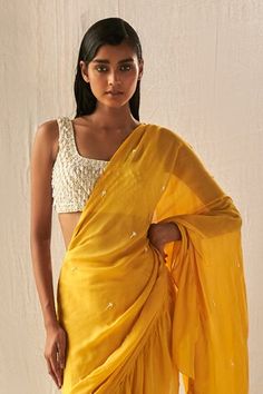 Yellow pre-draped saree with layered tiered panels, ruffle border, pleated draped details, floral embroidered highlights and attached pallu. Paired contrast blouse with all over checkered pattern, contrast cut dana, crystal tassels and sequin embroidery. - Aza Fashions Summer Pre-draped Saree With Sheer Dupatta, Elegant Traditional Drape Summer Blouse, Elegant Pre-draped Saree With Dupatta For Summer, Summer Cutdana Blouse Piece In Traditional Drape, Summer Wedding Blouse With Traditional Drape, Crystal Blouse, Ruffle Sarees, Draped Saree, Pleated Drapes