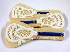 two cookies shaped like tennis racquets with blue handles