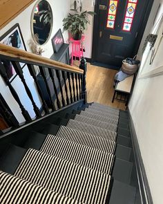 a staircase with black and white striped carpet