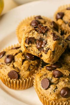 chocolate chip muffins stacked on top of each other on a white platter