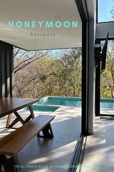 a wooden bench sitting next to a swimming pool